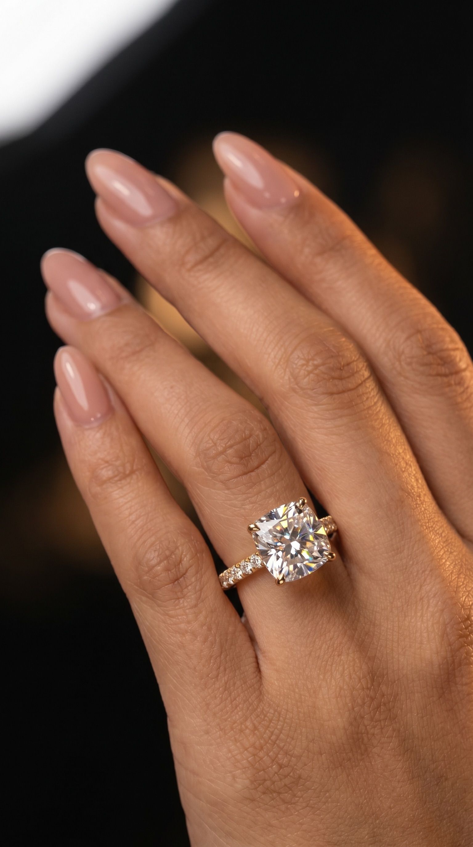 Cushion cathedral sidestone ring worn on hand